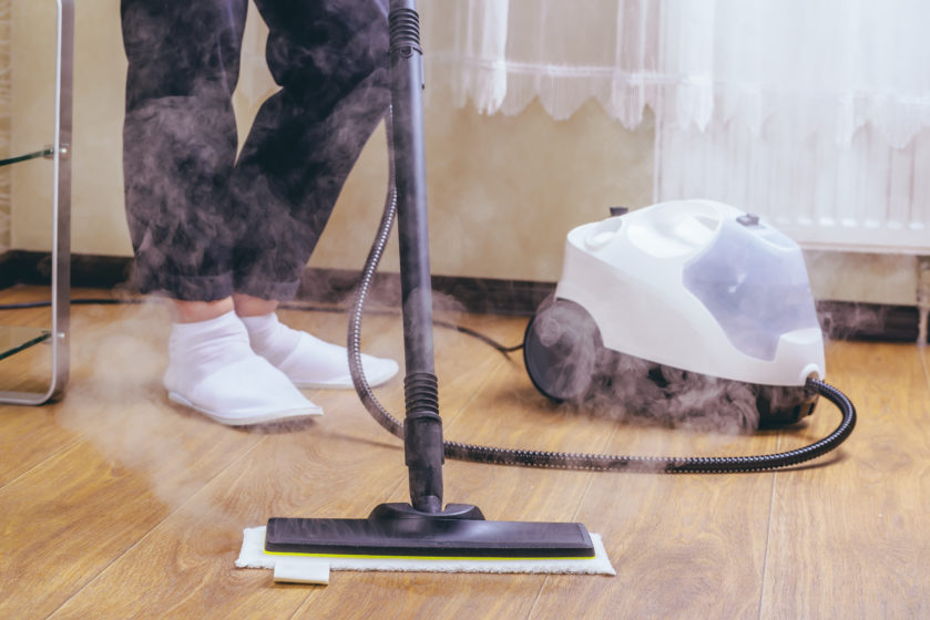 Man Cleaning Floor with Vacuum Cleaner