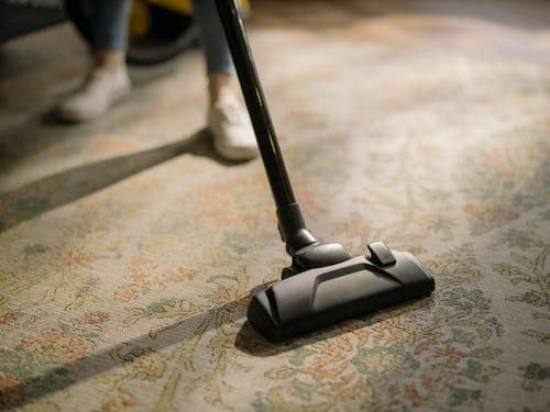 Vacuuming a carpeted surface