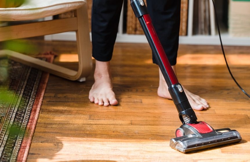 Man without Slippers Holding Vacuum Cleaner